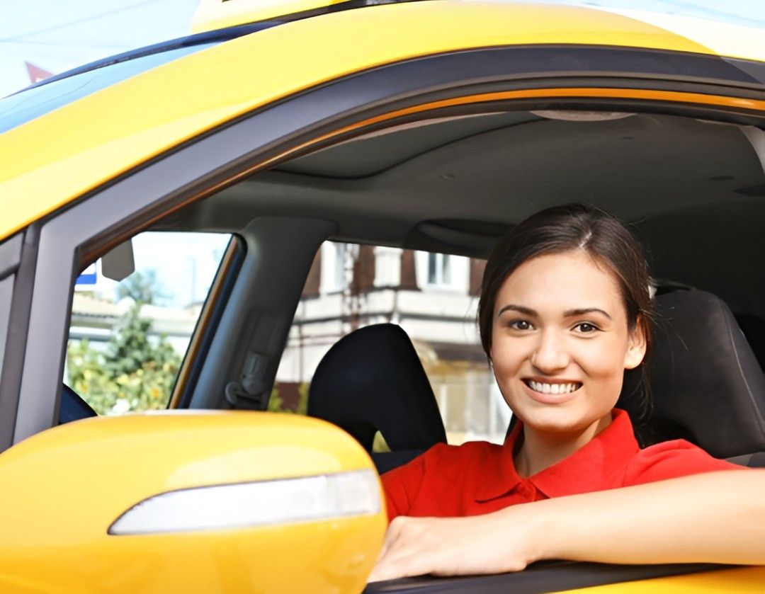 Person getting into a yellow cab with a smile
