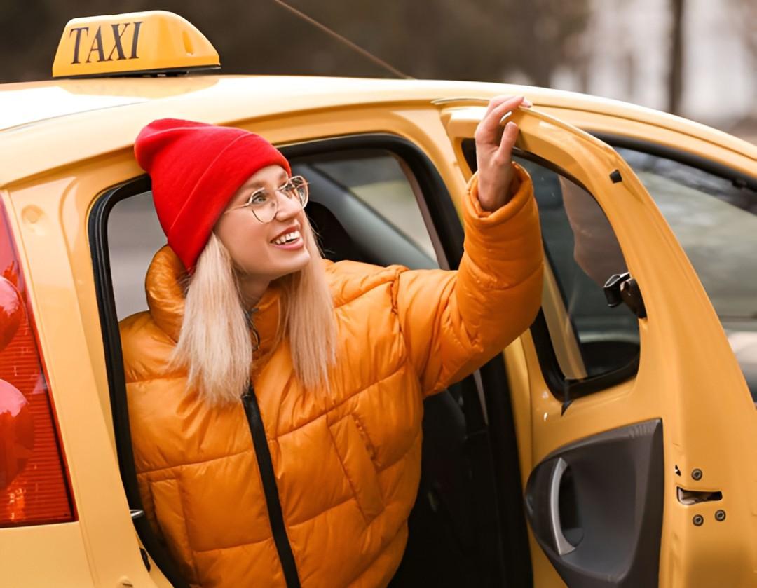 Person getting into a yellow cab with a smile